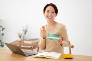 通帳を手に持った笑顔の女性