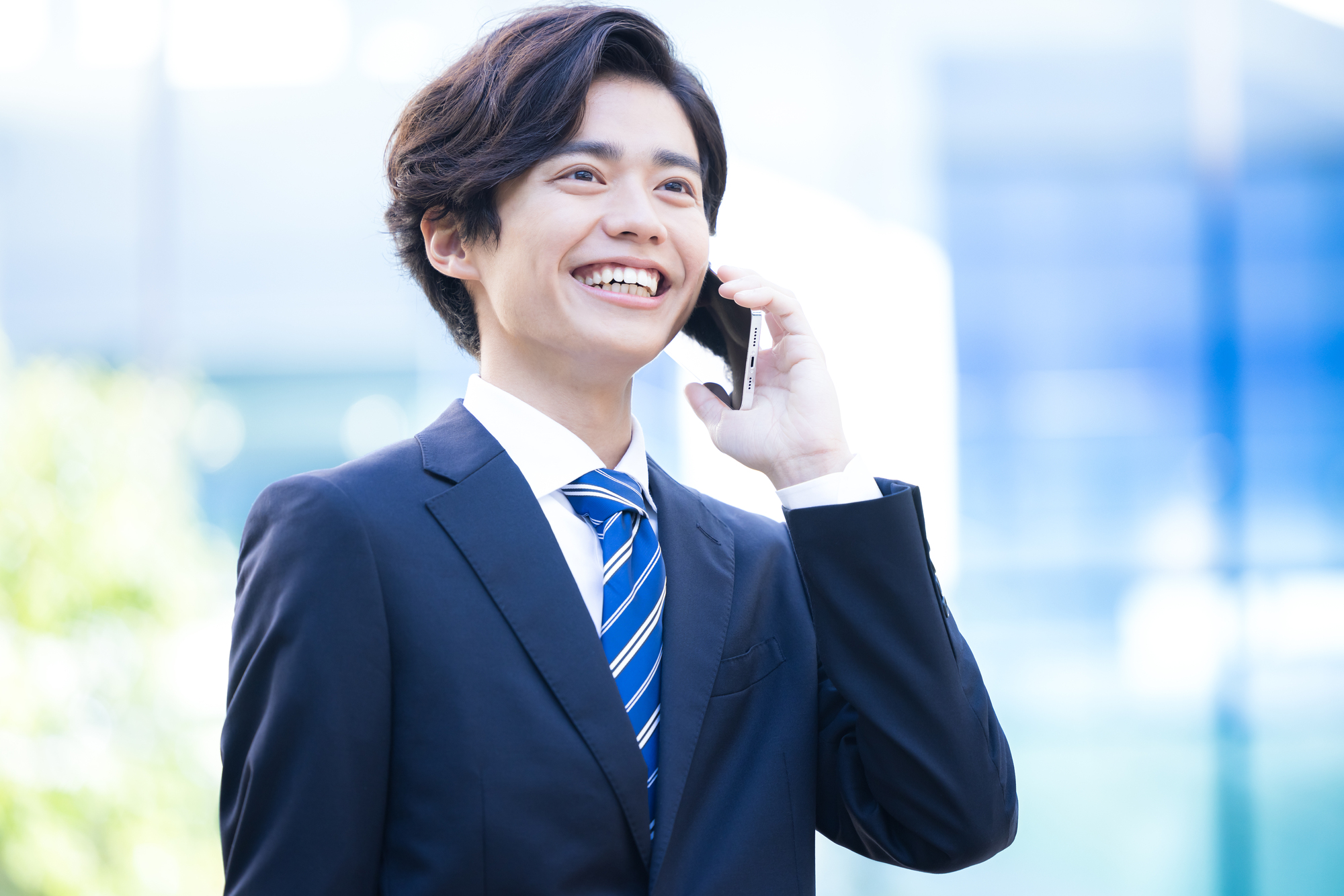 笑顔で通話をするビジネスパーソン
