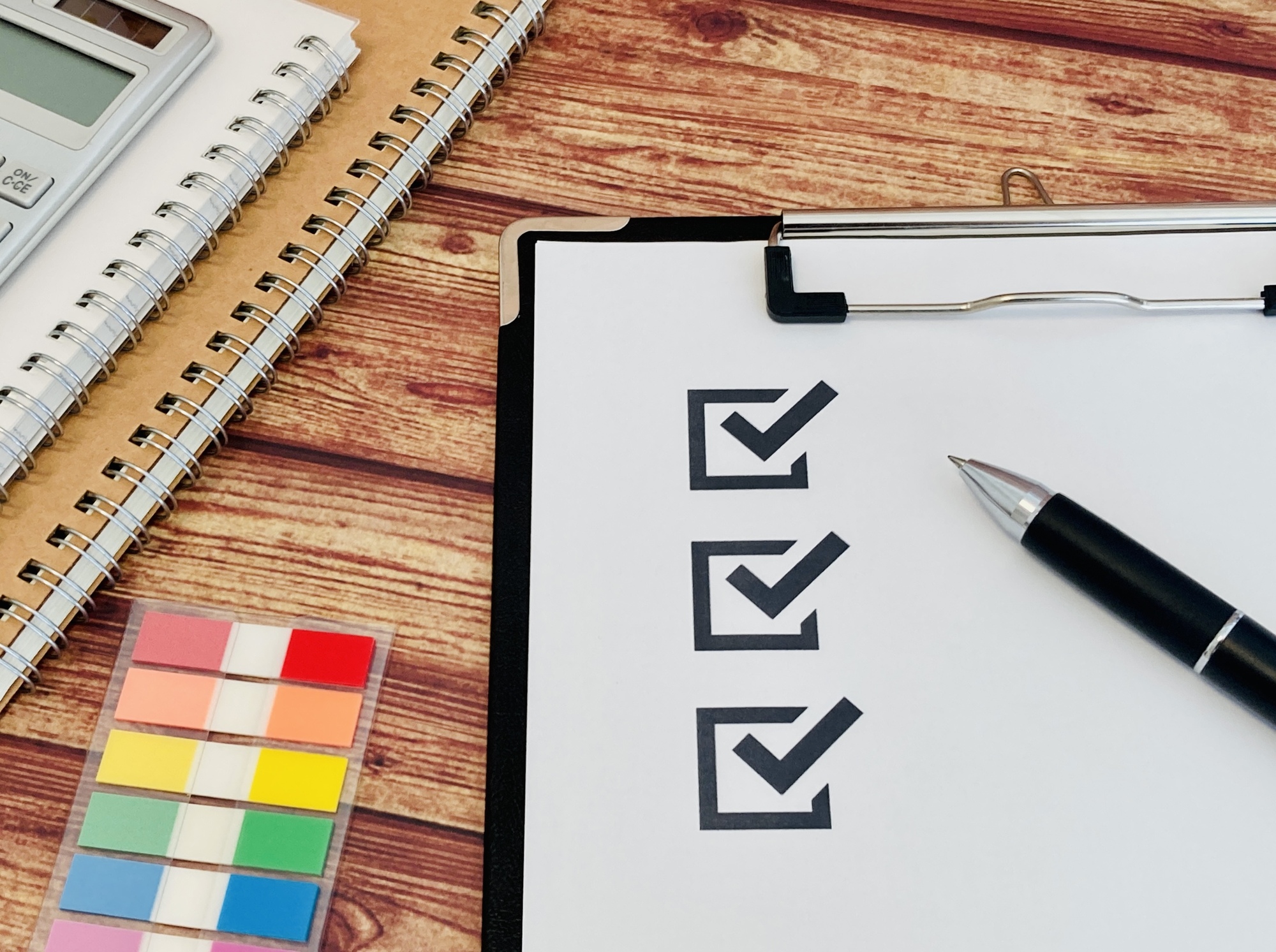 チェックが入った3つのチェックボックスとペン、付箋、ノート
