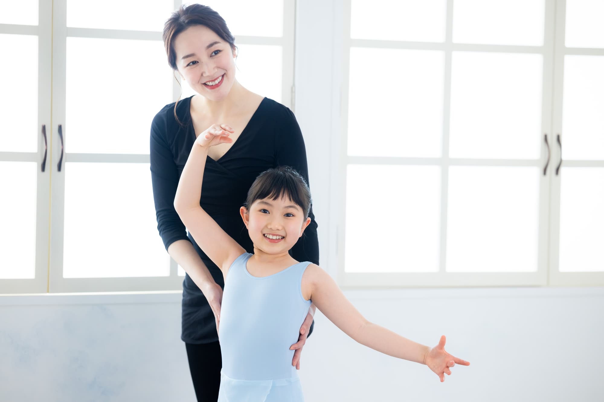 笑顔で指導をしているバレエ講師と生徒